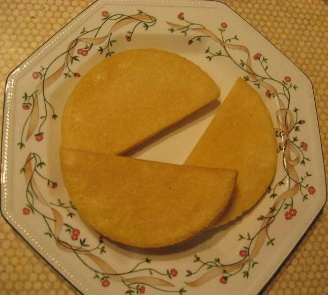 A plate displaying three pieces of Bammies, cut in half-circle shapes