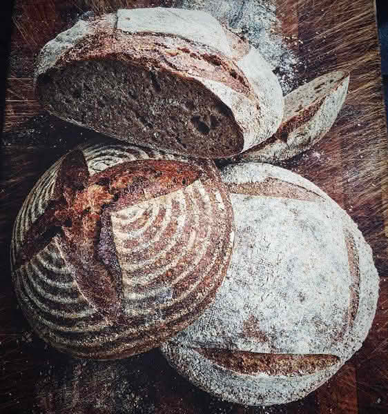 High-angle close-up view of several loaves of artisan bread