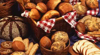 A selection of various breads elegantly arranged on a table, showcasing different shapes and textures
