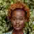 A woman named Olivia Ava with a stylish afro hairstyle, radiating confidence and charm