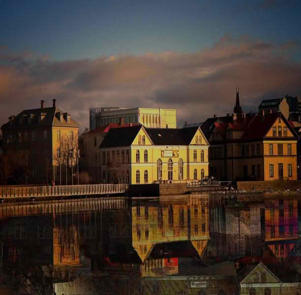 A panoramic view of a large body of water in Reykjavik, reflecting the city's skyline and surrounding landscapes